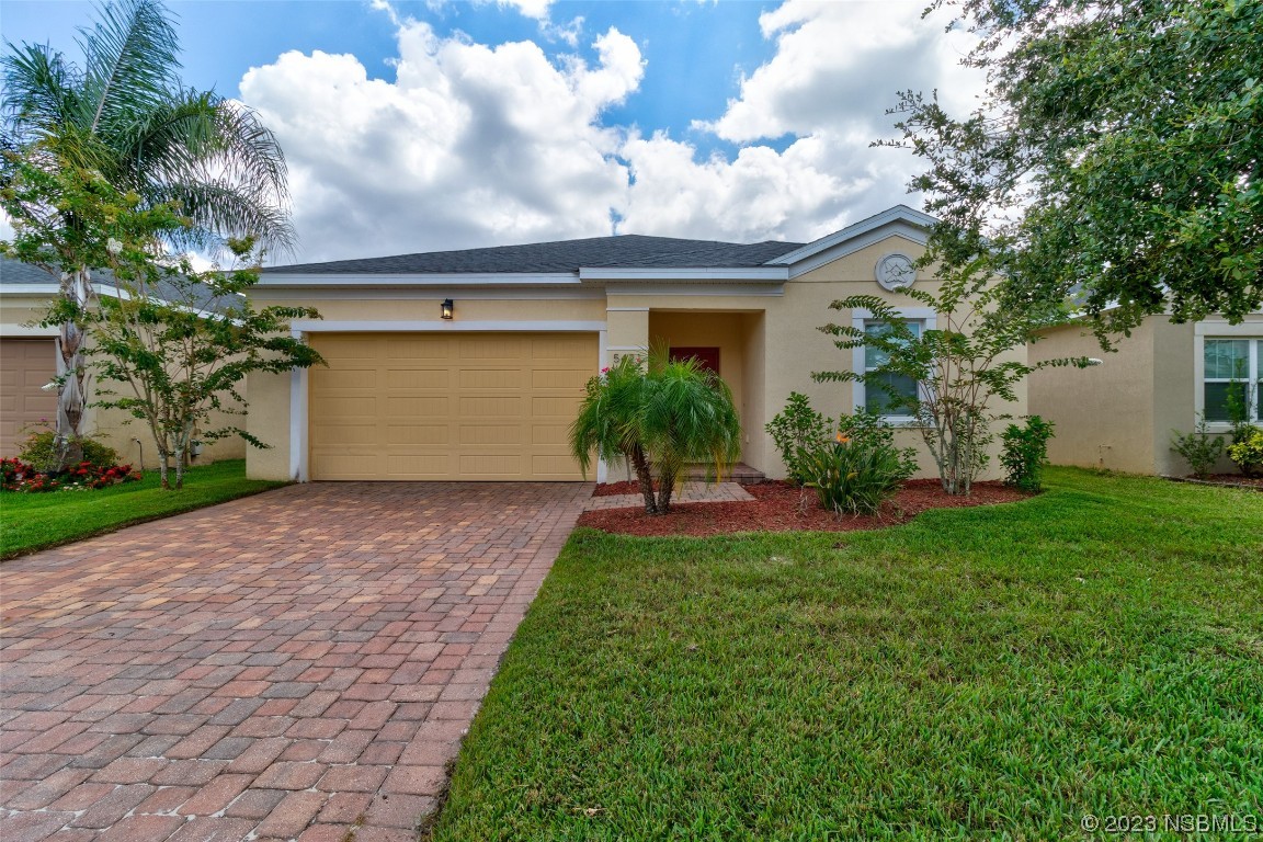 5421 Estero Loop Port Orange, FL 32128 - Photo 1 of 30 a front view of a house with a yard and a garage