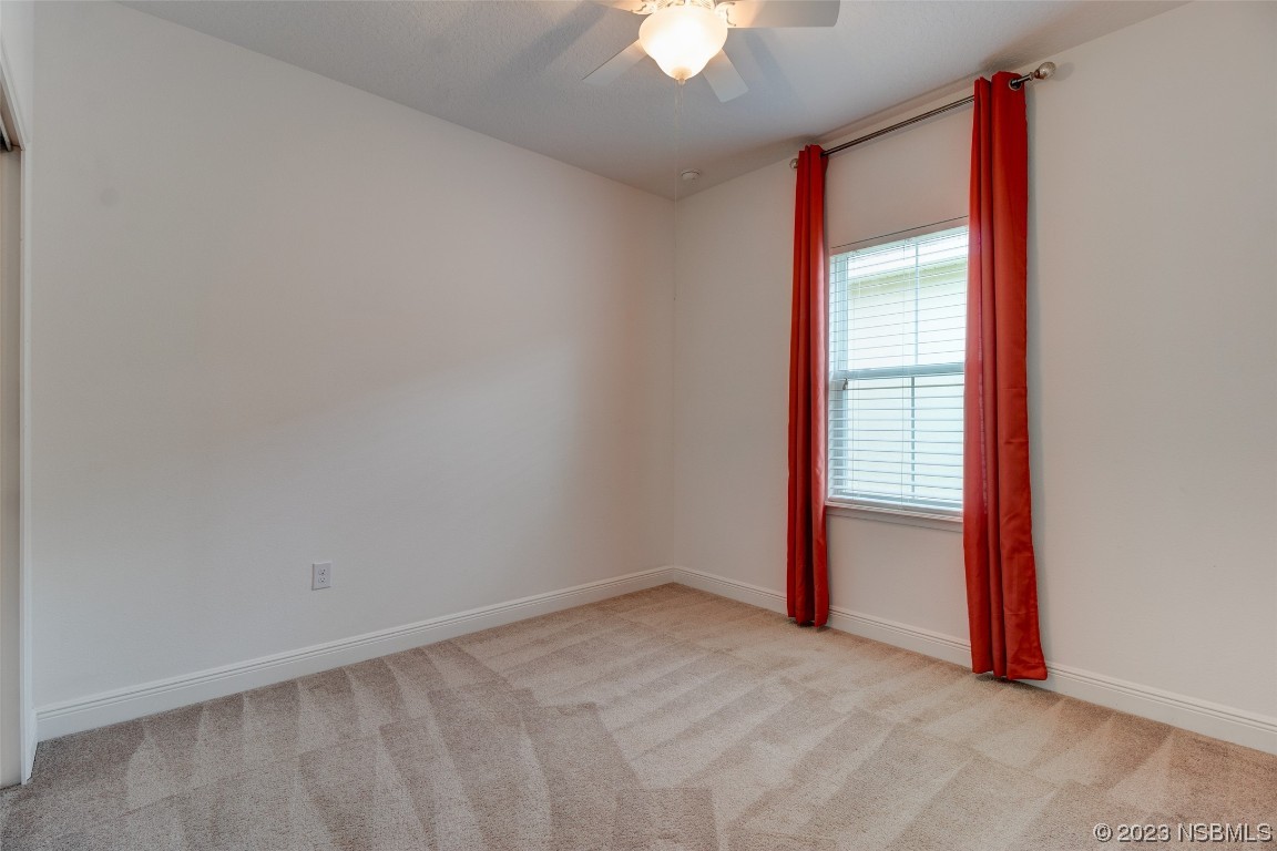 5421 Estero Loop Port Orange, FL 32128 - Photo 12 of 30 an empty room with a empty space and a ceiling fan