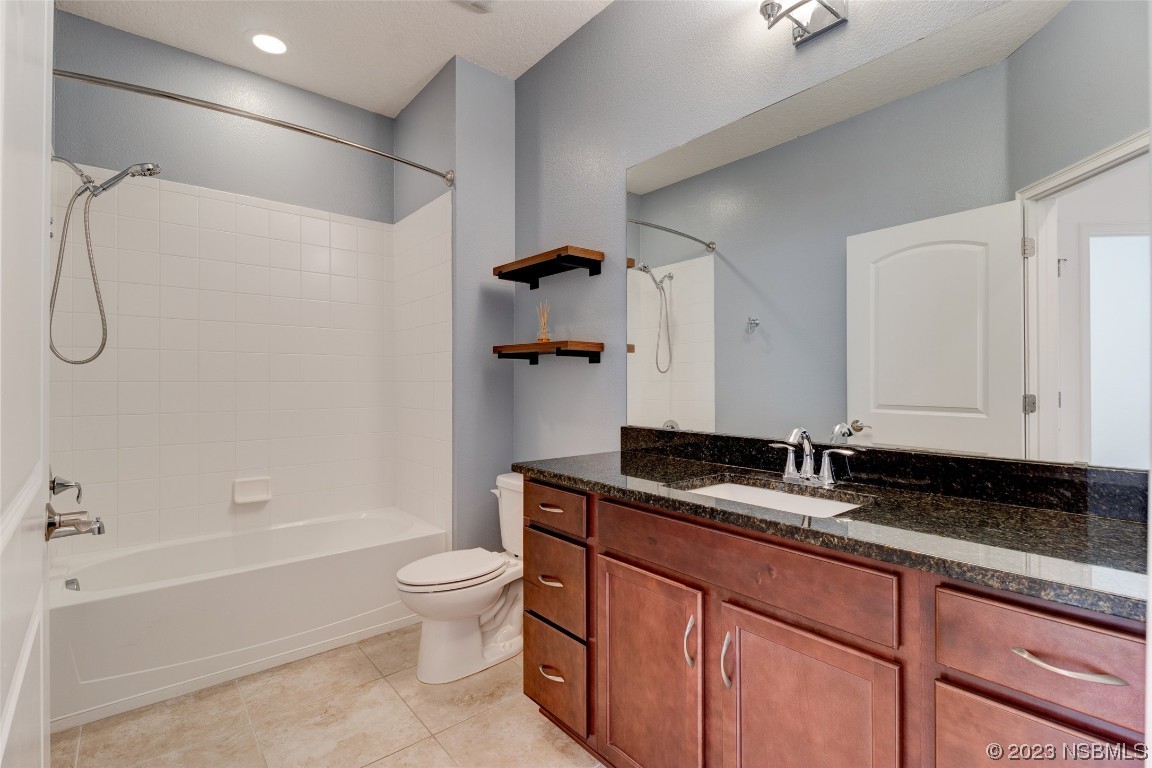 5421 Estero Loop Port Orange, FL 32128 - Photo 14 of 30 a bathroom with a granite countertop sink a toilet and bathtub