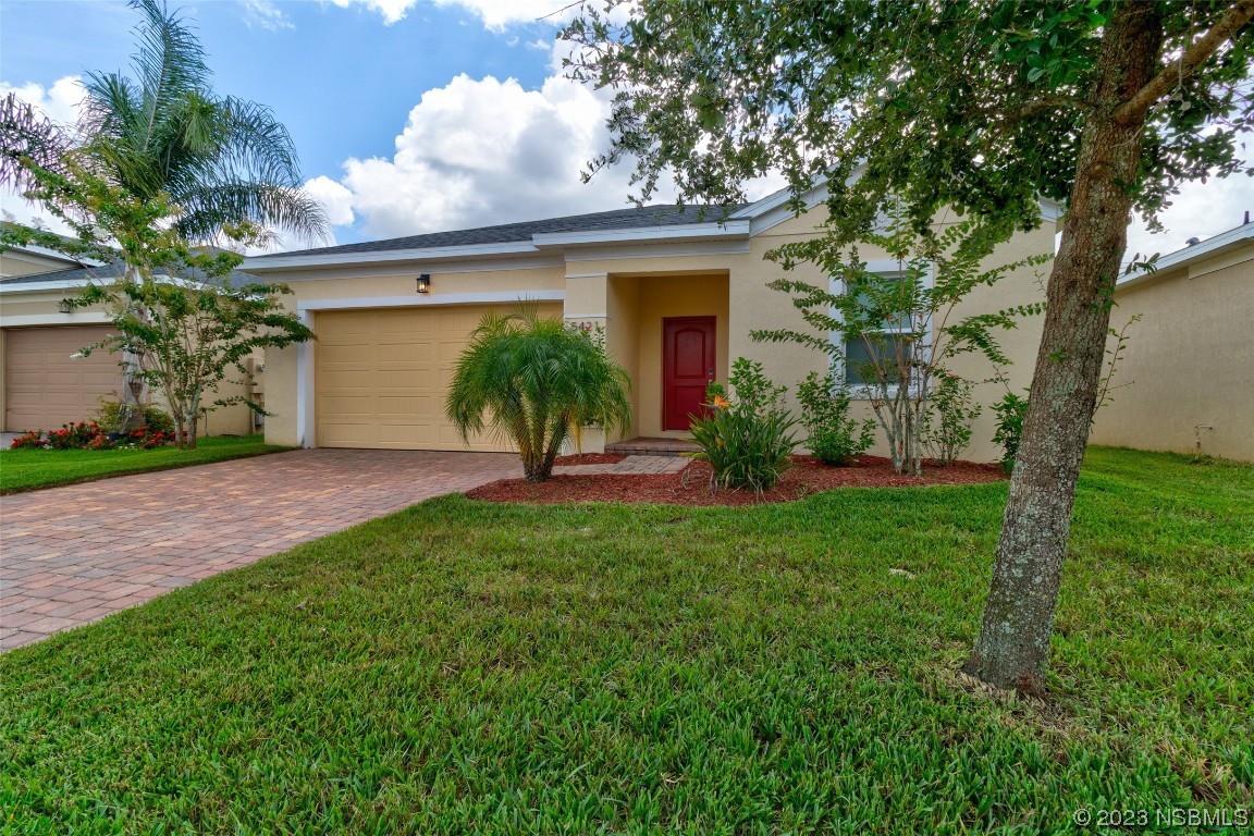 5421 Estero Loop Port Orange, FL 32128 - Photo 3 of 30 a front view of house with yard and green space
