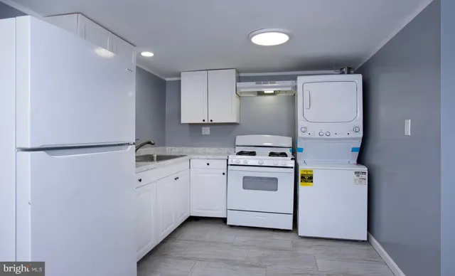 a view of a house with wooden fence