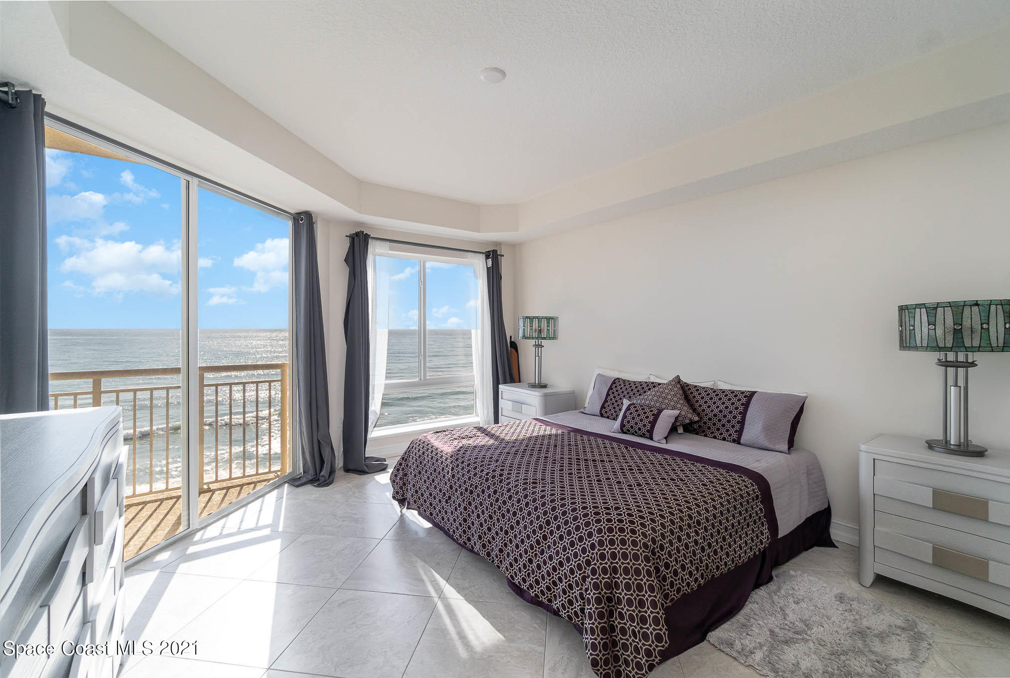 1045 Florida A1A, Unit 503 Satellite Beach, FL 32937 - Photo 11 of 23 a bedroom with bed and glass window