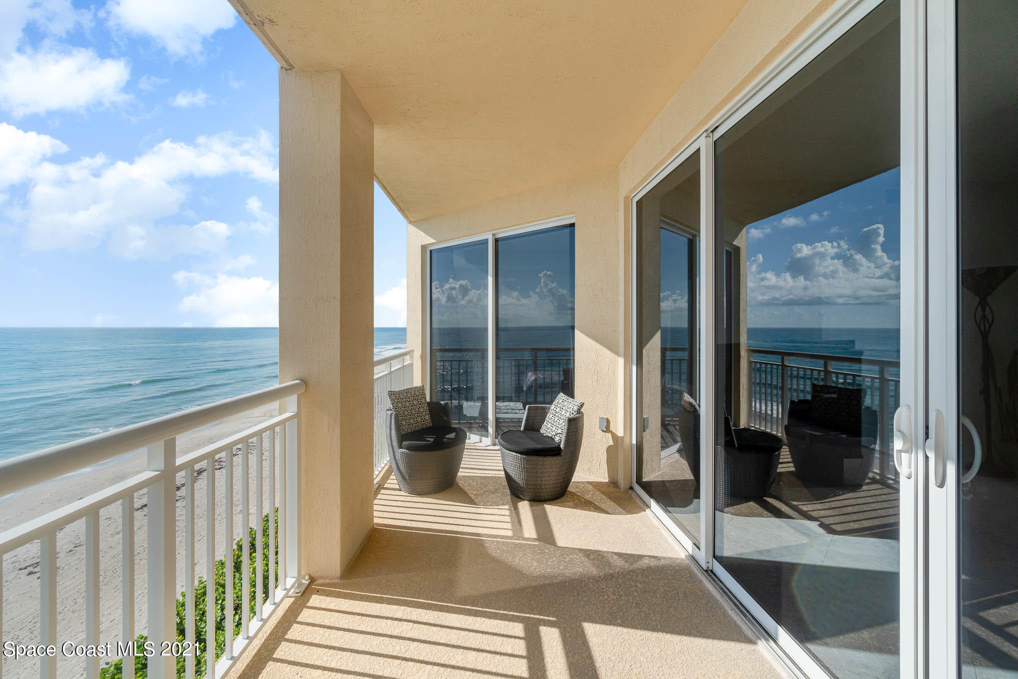 1045 Florida A1A, Unit 503 Satellite Beach, FL 32937 - Photo 19 of 23 a balcony with furniture and a potted plant