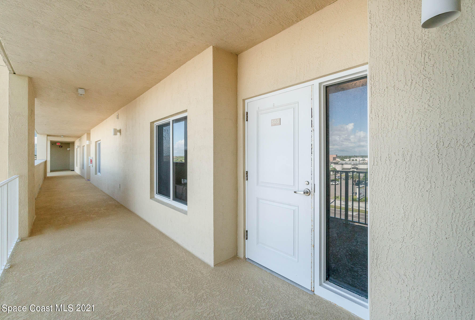 1045 Florida A1A, Unit 503 Satellite Beach, FL 32937 - Photo 22 of 23 a view of a hallway with wooden shelves