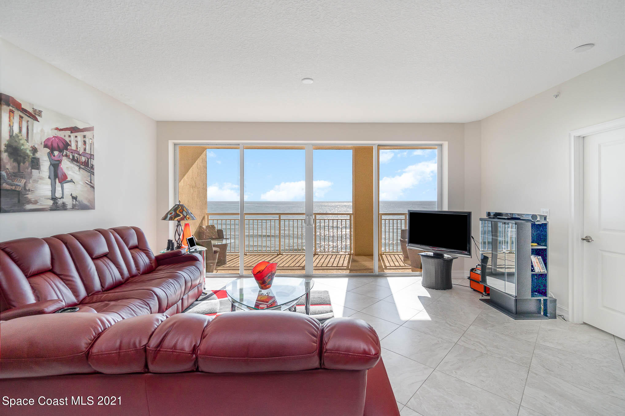 1045 Florida A1A, Unit 503 Satellite Beach, FL 32937 - Photo 5 of 23 a living room with furniture and a flat screen tv