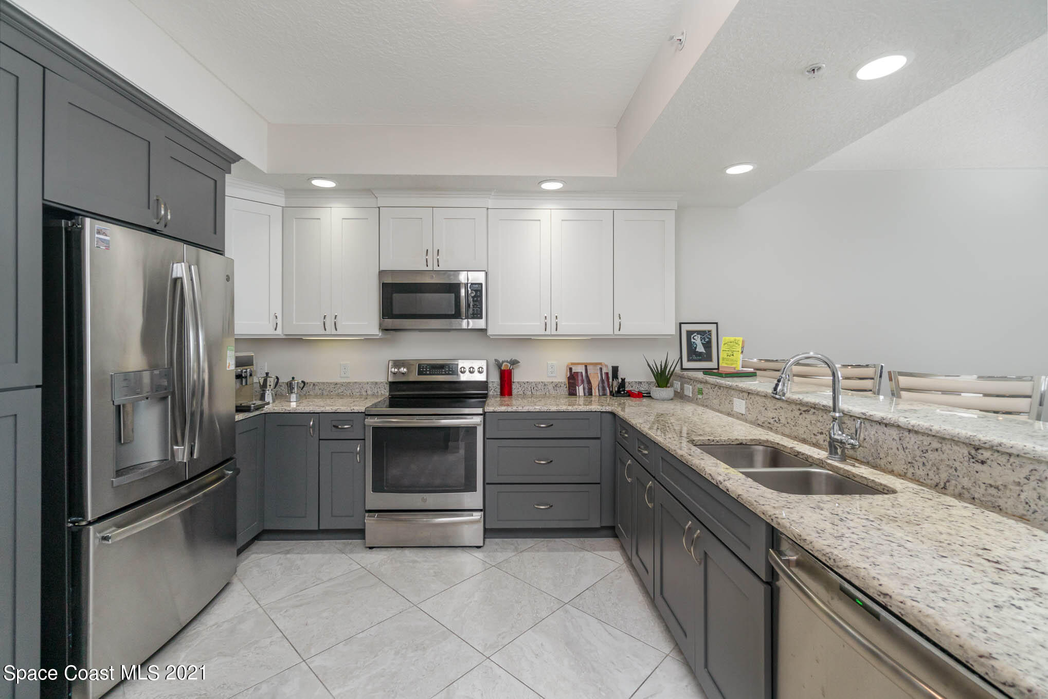 1045 Florida A1A, Unit 503 Satellite Beach, FL 32937 - Photo 9 of 23 a kitchen with a sink stove and refrigerator