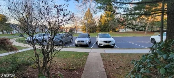 a view of a yard with cars parked
