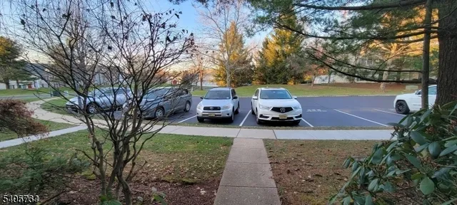 a view of a yard with cars parked