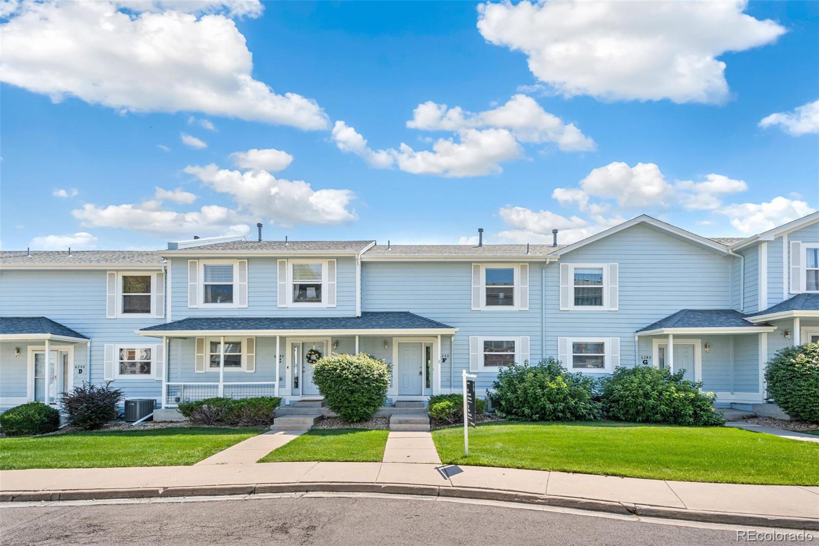 a view of a brick building next to a yard