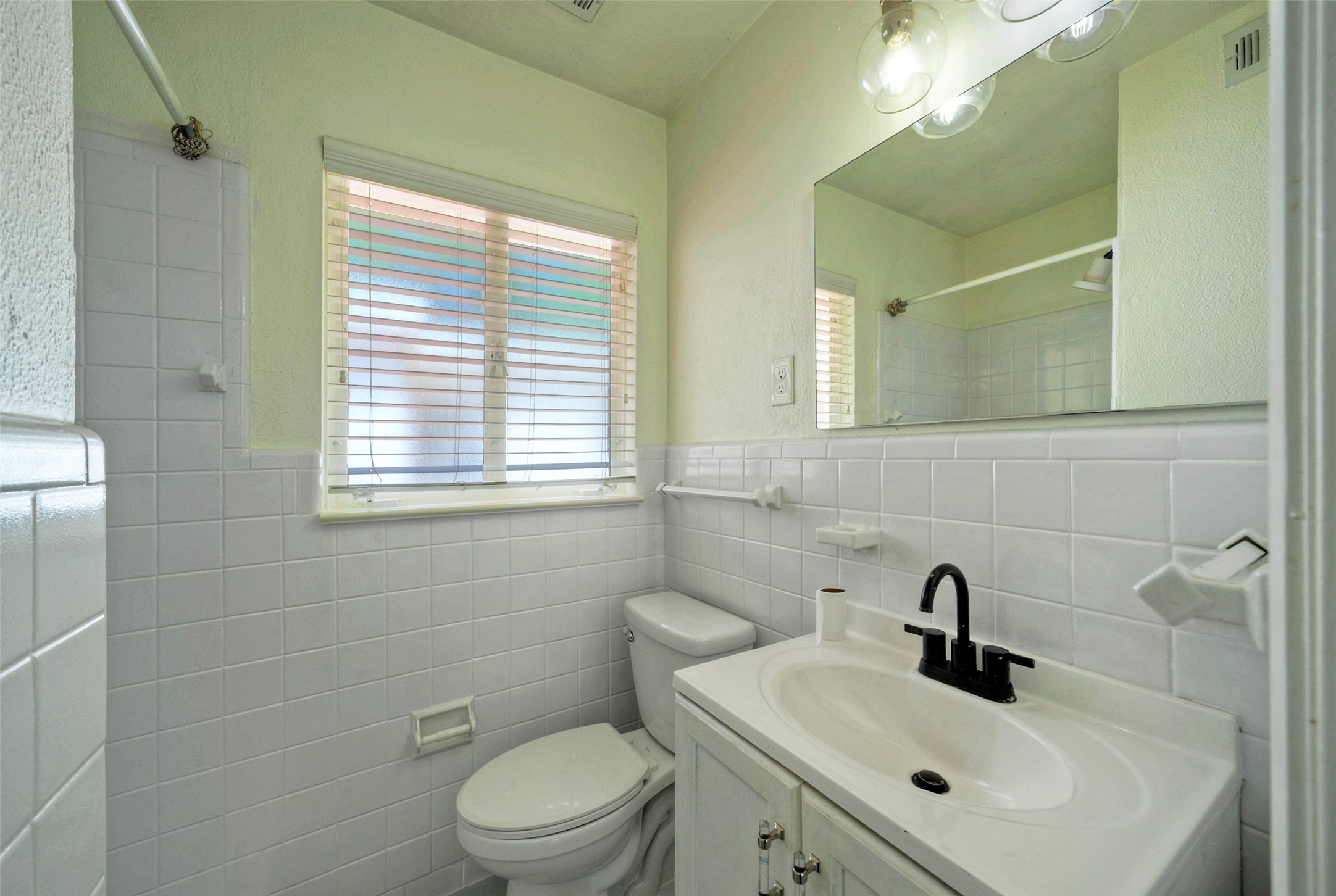 1803 Pearl Street Austin, TX 78701 - Photo 14 of 33 a bathroom with a sink a toilet and a mirror