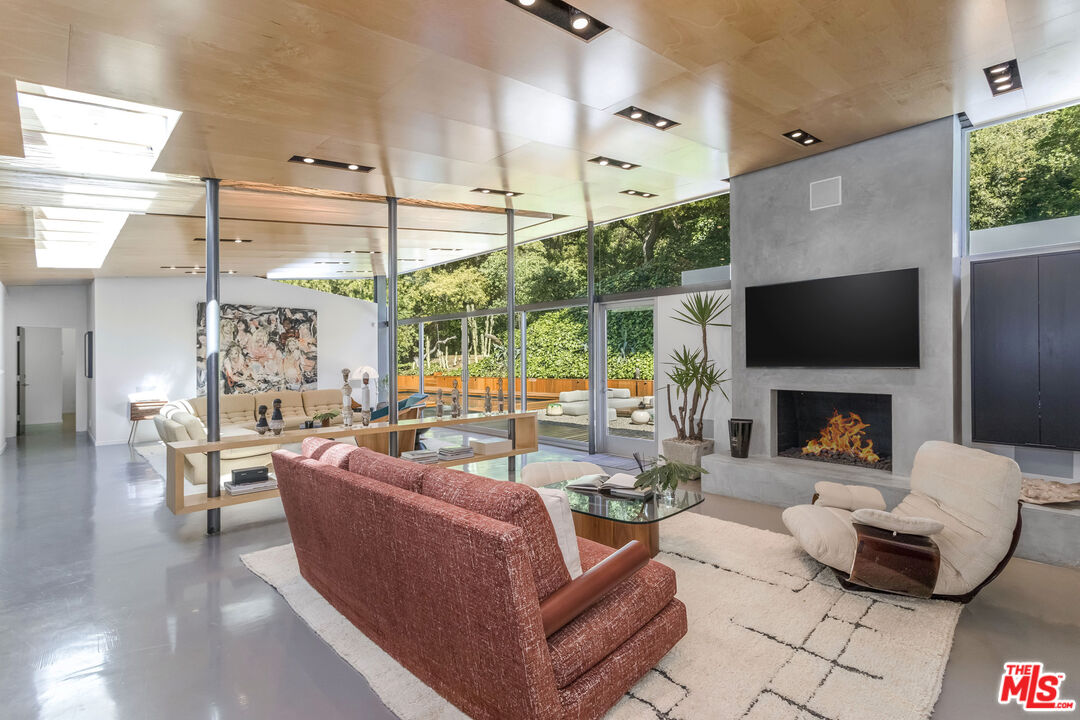 2538 Hutton Drive Beverly Hills, CA 90210 - Photo 13 of 63 a living room with fireplace furniture and a flat screen tv