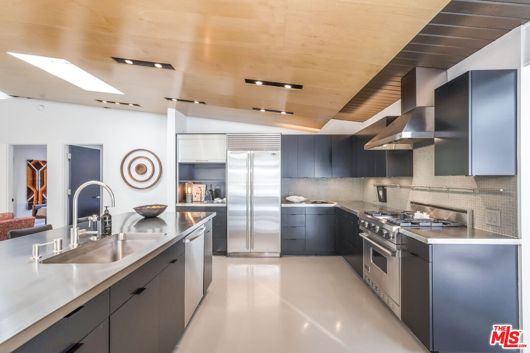 2538 Hutton Drive Beverly Hills, CA 90210 - Photo 19 of 63 a kitchen with stainless steel appliances granite countertop a sink stove and refrigerator
