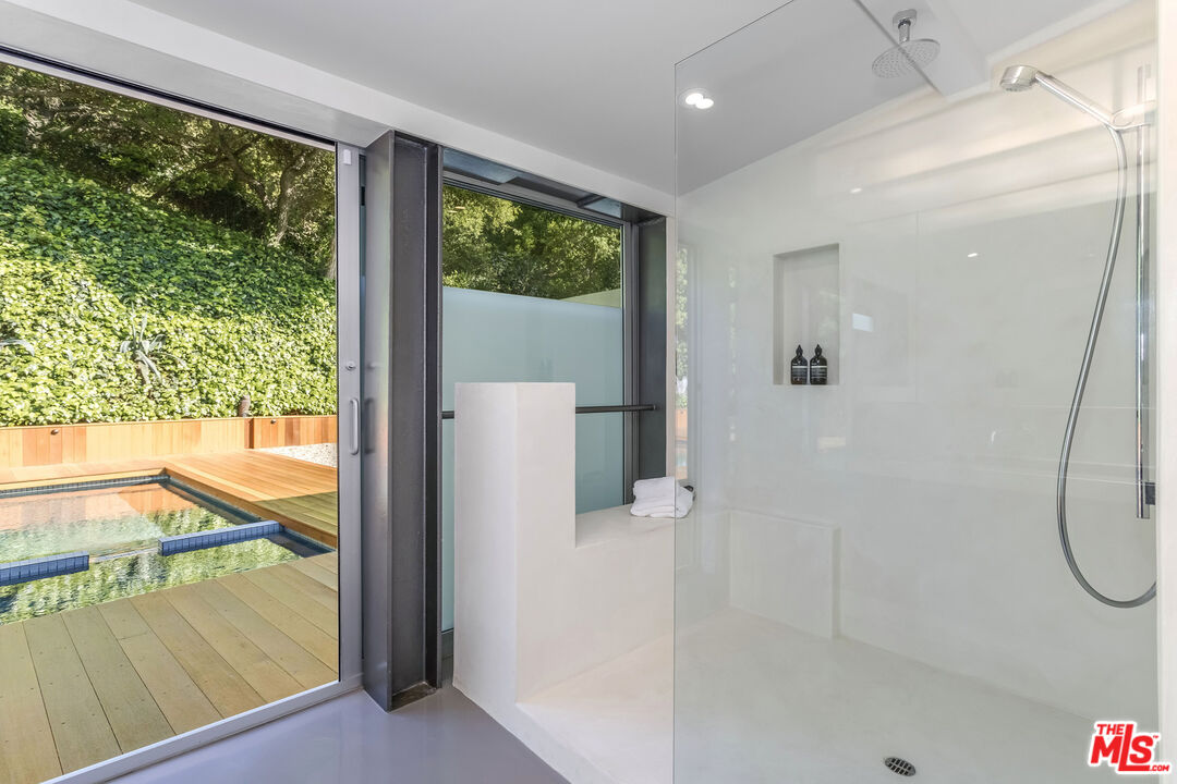 2538 Hutton Drive Beverly Hills, CA 90210 - Photo 31 of 63 a bathroom with a shower and a window