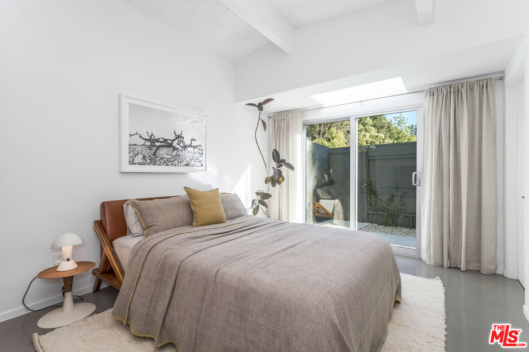 2538 Hutton Drive Beverly Hills, CA 90210 - Photo 35 of 63 a bedroom with a large bed and a large window