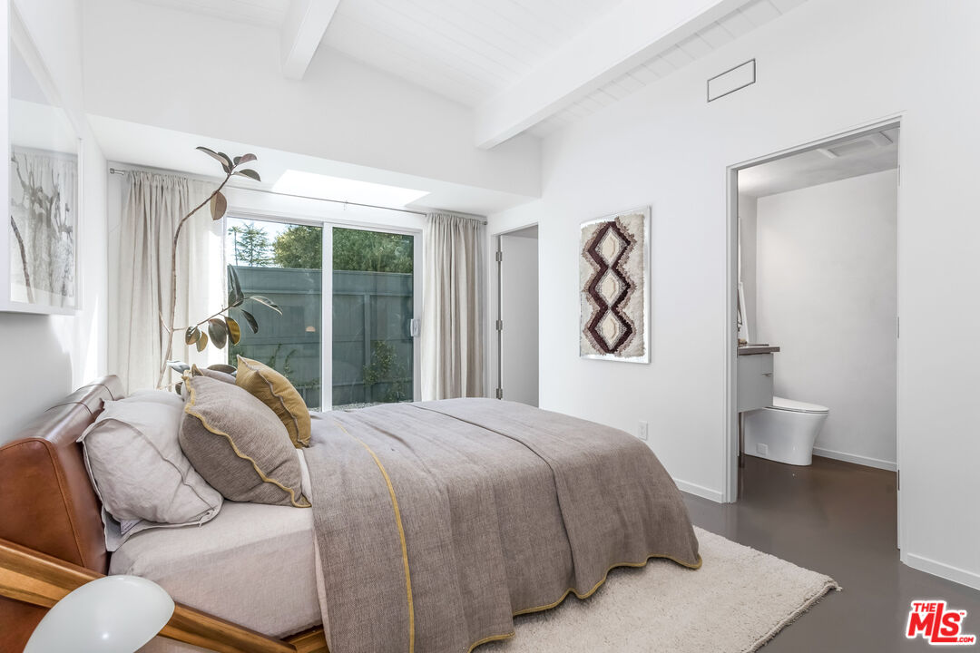 2538 Hutton Drive Beverly Hills, CA 90210 - Photo 36 of 63 a bedroom with a bed and window