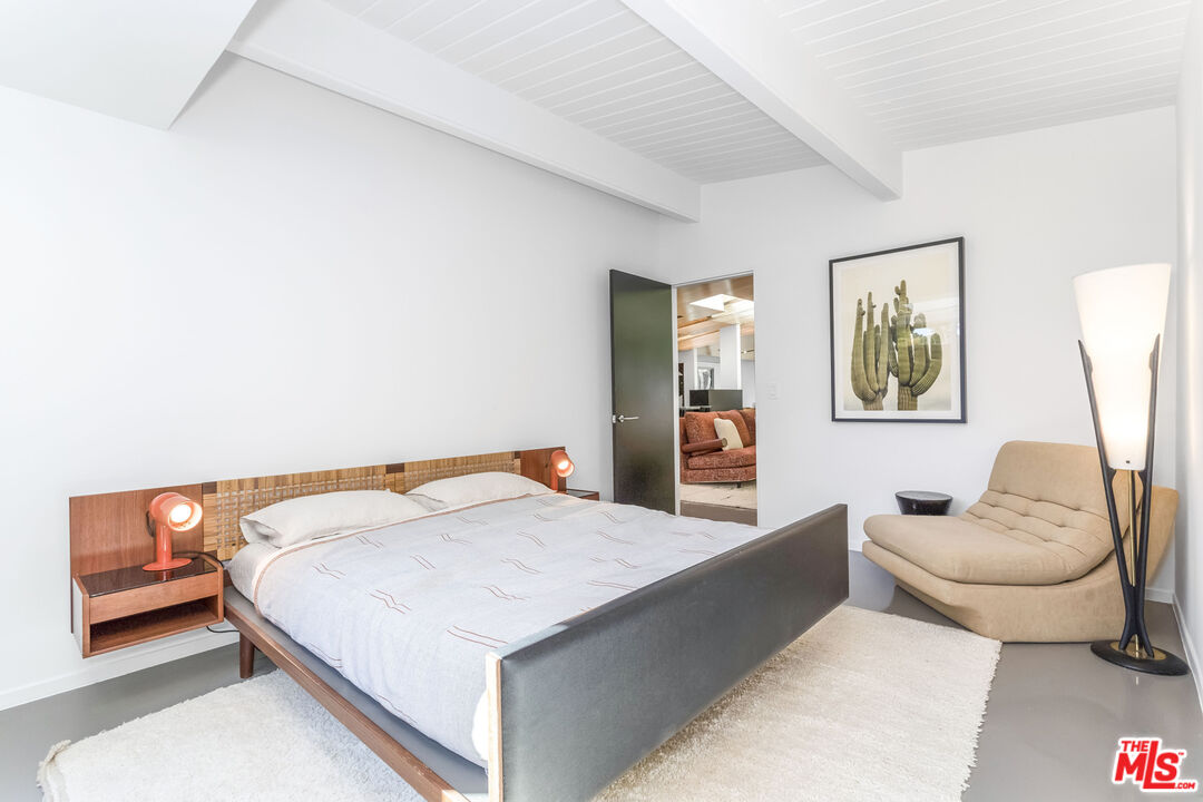 2538 Hutton Drive Beverly Hills, CA 90210 - Photo 38 of 63 a bedroom with a bed couch and painting on the wall