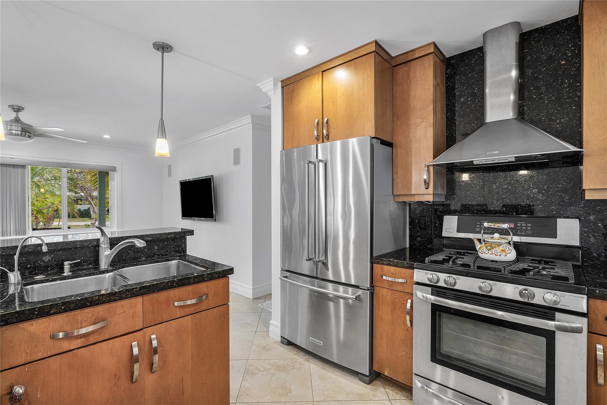290 Northeast 29th Street Boca Raton, FL 33431 - Photo 12 of 48 a kitchen with stainless steel appliances granite countertop a refrigerator a stove a microwave a sink and white cabinets