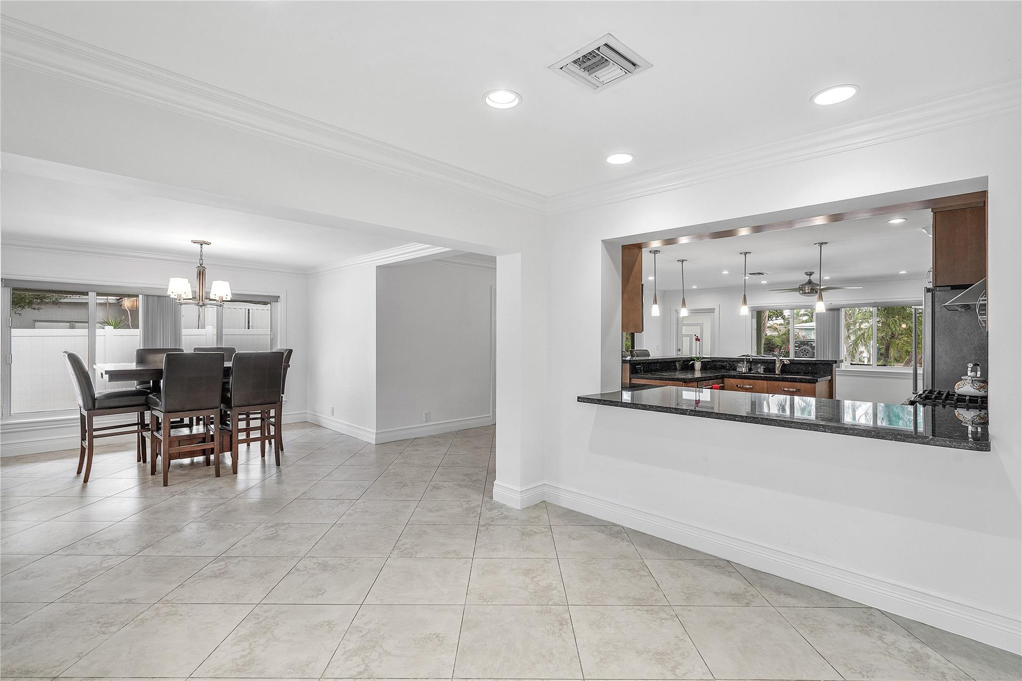 290 Northeast 29th Street Boca Raton, FL 33431 - Photo 17 of 48 a dining hall with stainless steel appliances a dining table and chairs