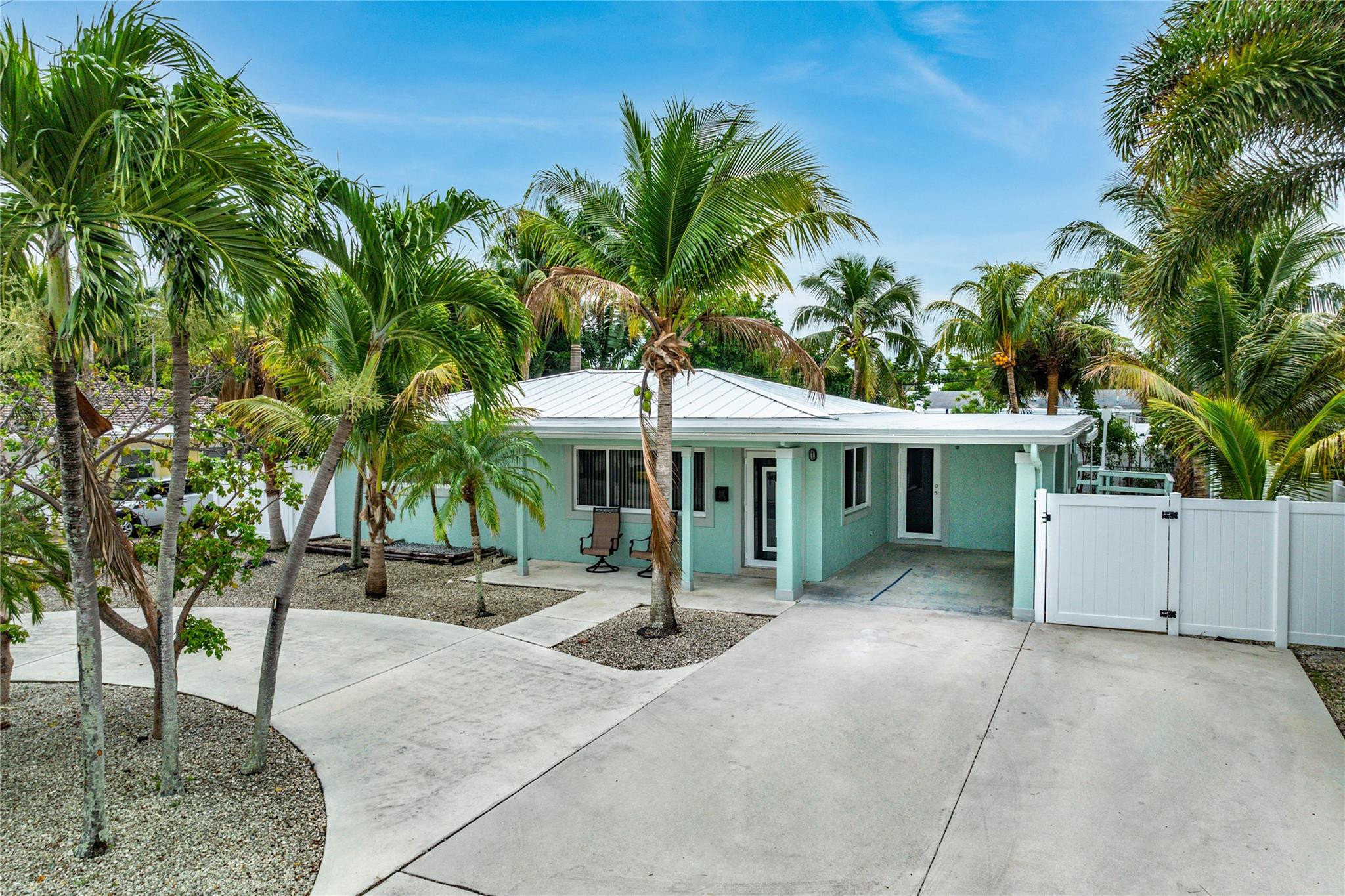 290 Northeast 29th Street Boca Raton, FL 33431 - Photo 2 of 48 a view of a house with a yard and potted plants