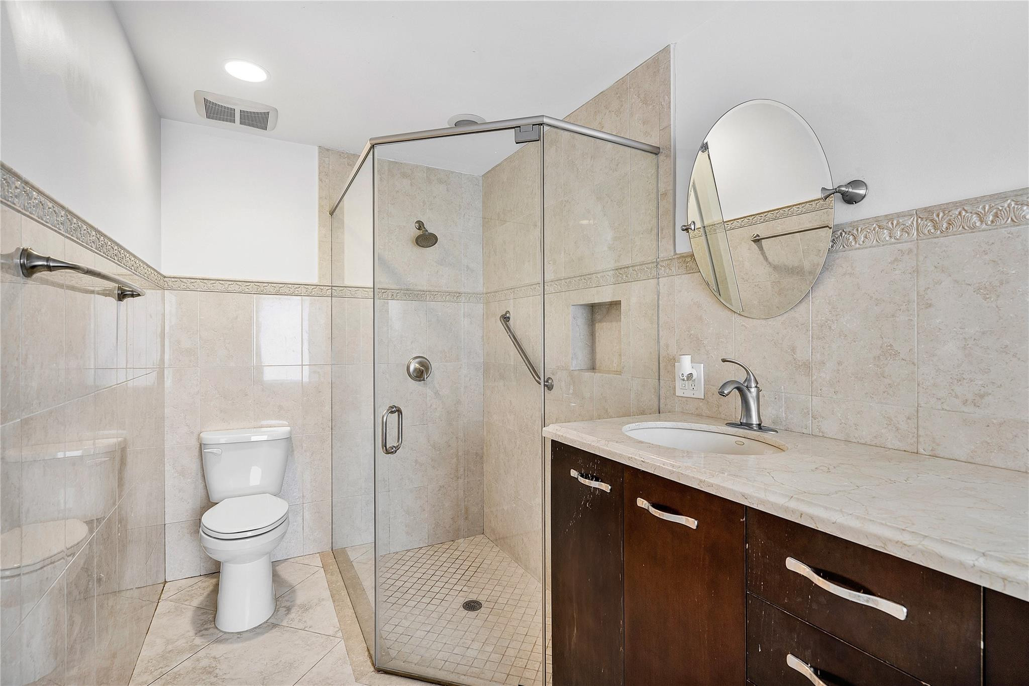 290 Northeast 29th Street Boca Raton, FL 33431 - Photo 23 of 48 a bathroom with a granite countertop sink a toilet a mirror and shower