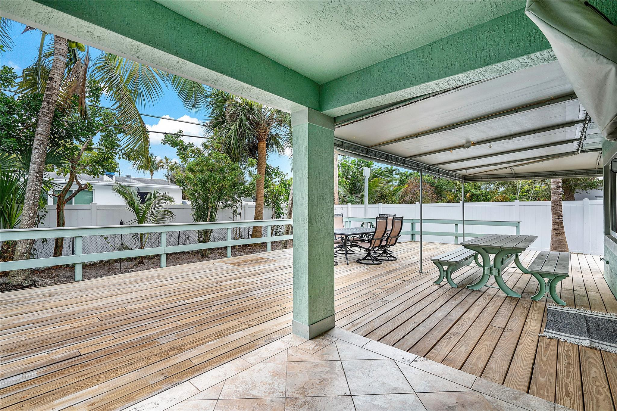 290 Northeast 29th Street Boca Raton, FL 33431 - Photo 33 of 48 a view of a patio with table and chairs and wooden floor