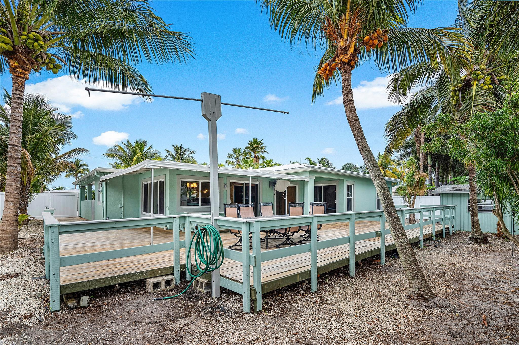290 Northeast 29th Street Boca Raton, FL 33431 - Photo 35 of 48 a front view of a house with a garden and furniture