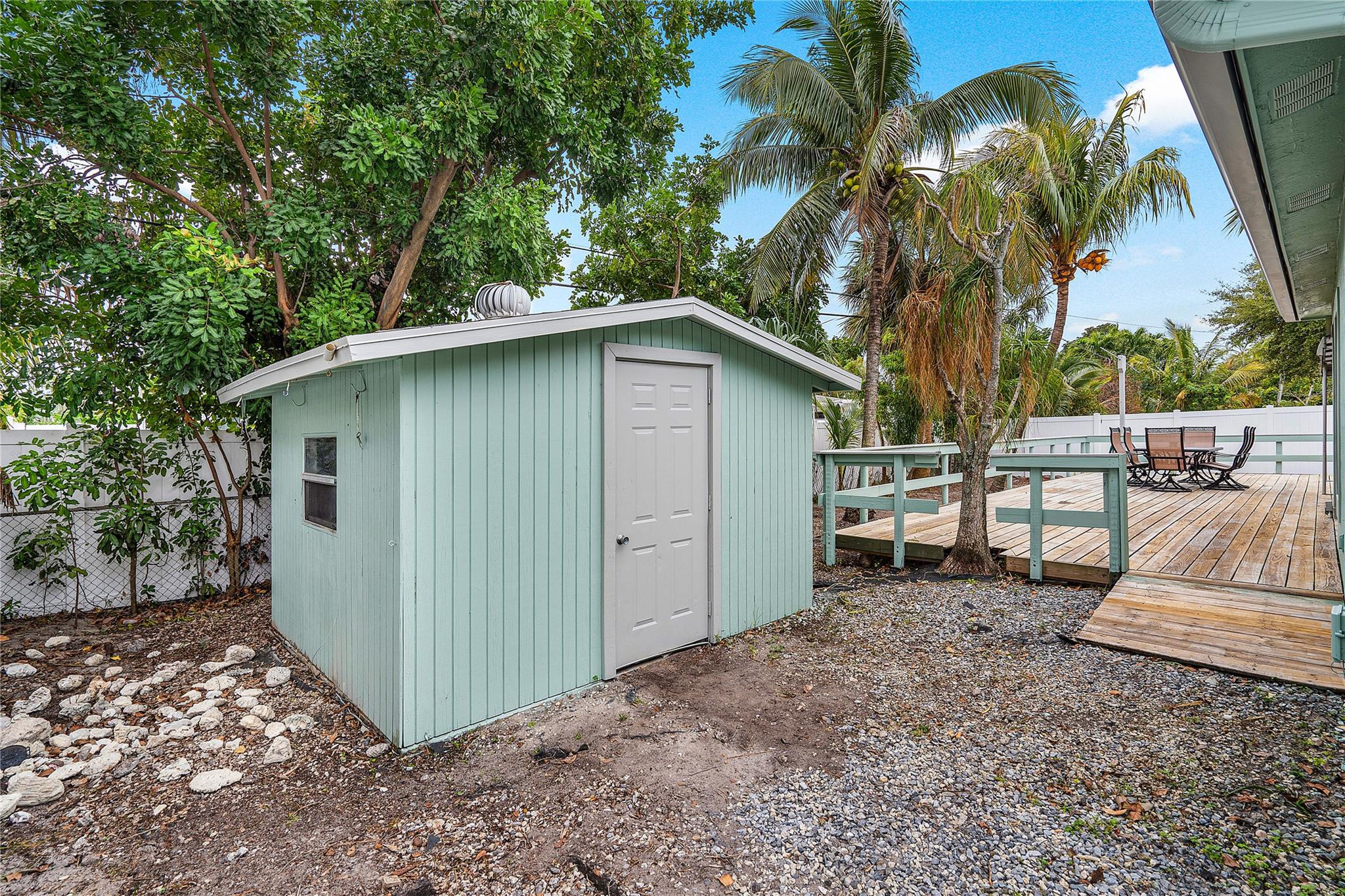 290 Northeast 29th Street Boca Raton, FL 33431 - Photo 38 of 48 a view of backyard with a table and chairs under an umbrella