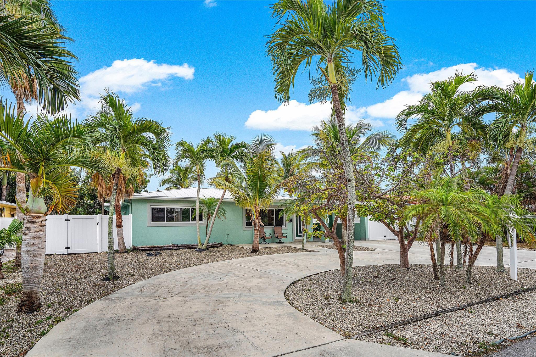 290 Northeast 29th Street Boca Raton, FL 33431 - Photo 4 of 48 a view of a house with a yard and palm trees