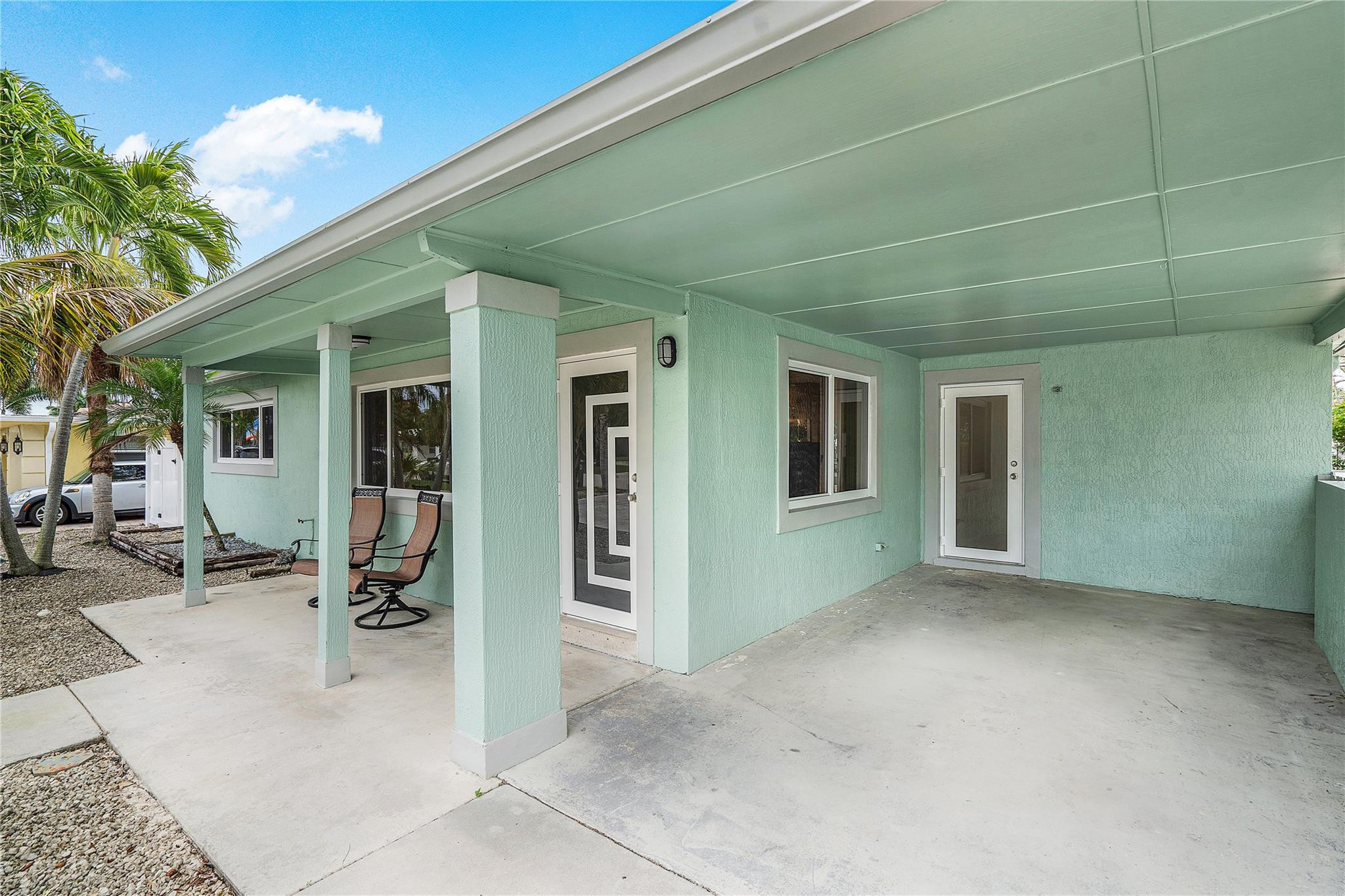 290 Northeast 29th Street Boca Raton, FL 33431 - Photo 5 of 48 a view of a patio with table and chairs under an umbrella