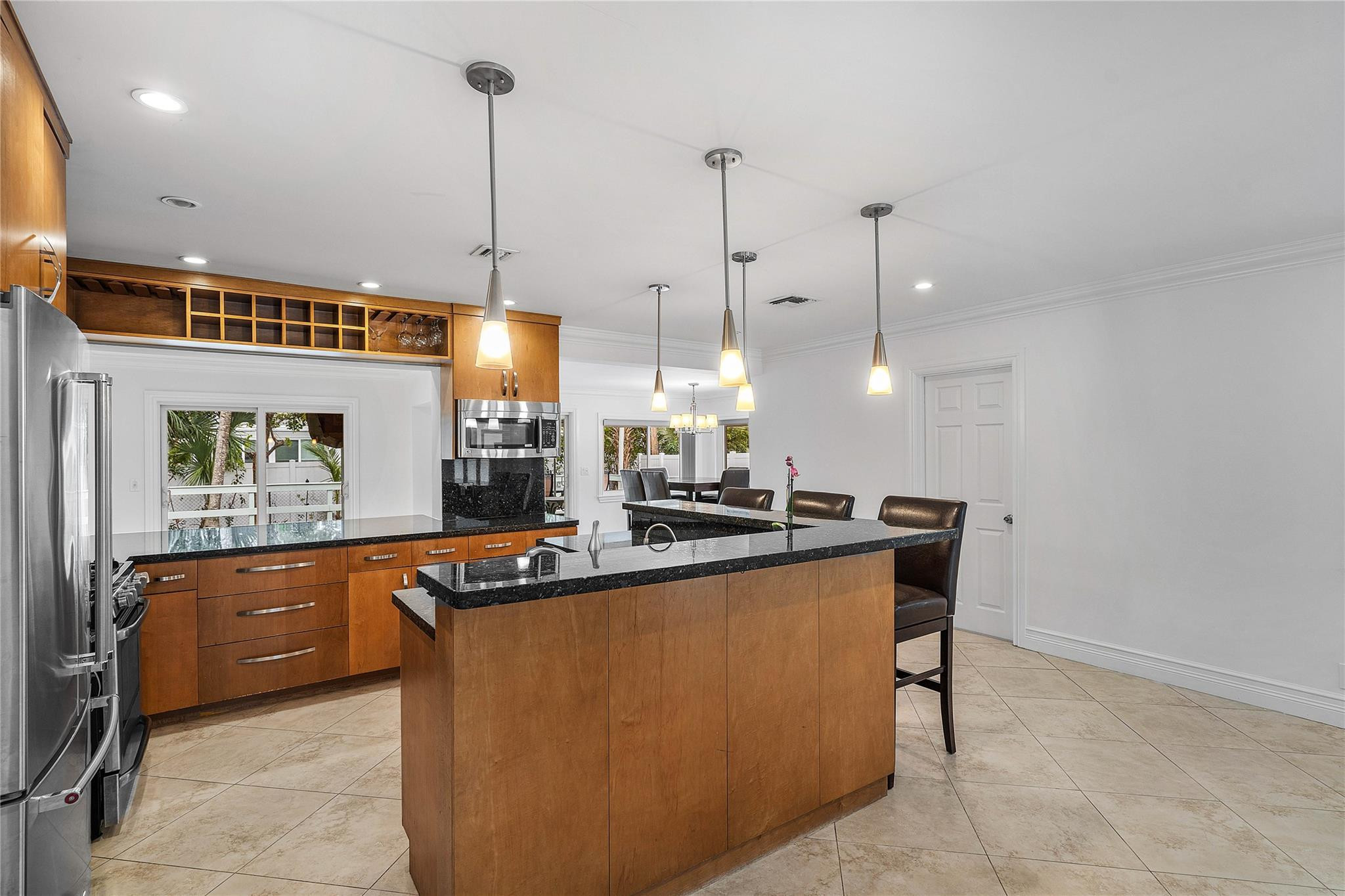 290 Northeast 29th Street Boca Raton, FL 33431 - Photo 9 of 48 a kitchen with stainless steel appliances granite countertop a sink a counter space and cabinets