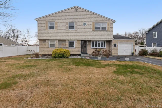 a front view of a house with yard and outdoor seating