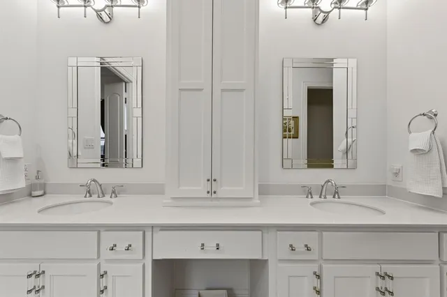 a bathroom with double vanity sink and a mirror