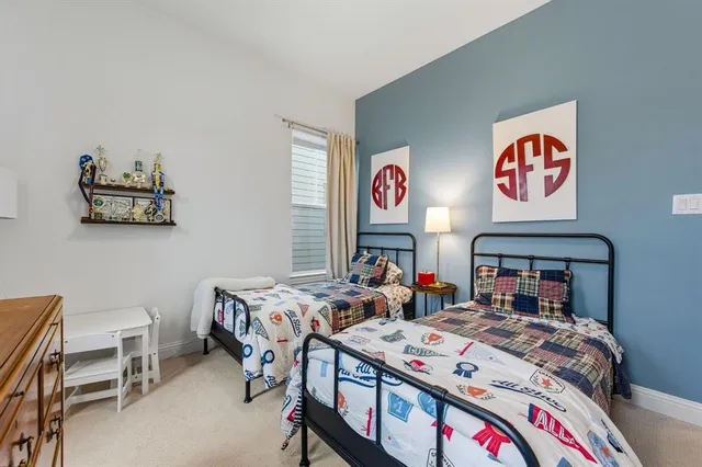 a bed room with a bed a desk and chair