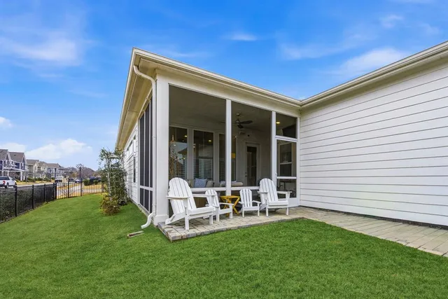 a view of a chair and tables in the backyard
