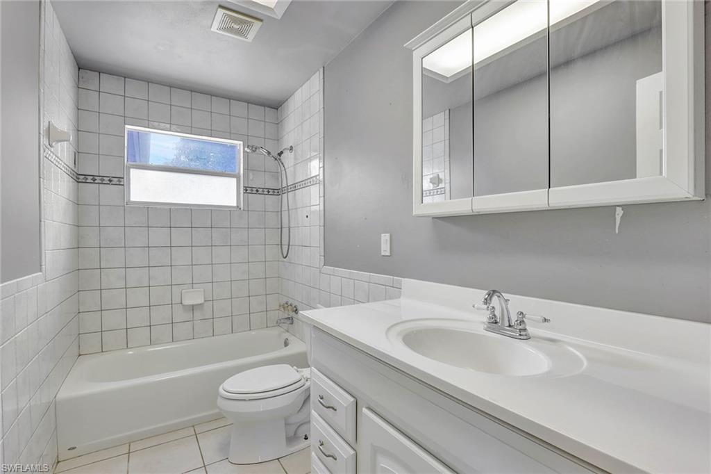 4656 Capri Drive Naples, FL 34103 - Photo 12 of 18 a bathroom with a sink a toilet and shower