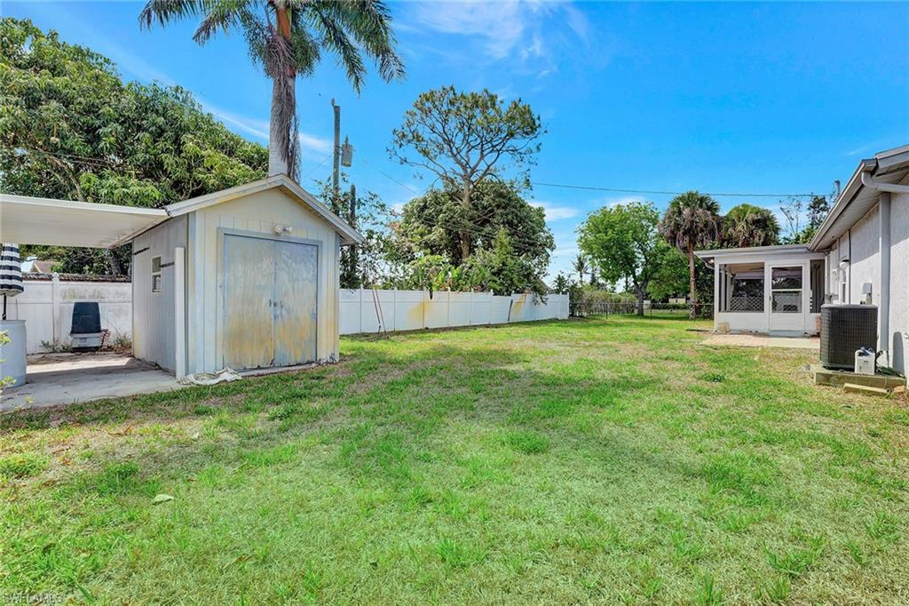 4656 Capri Drive Naples, FL 34103 - Photo 16 of 18 a view of a house with a yard