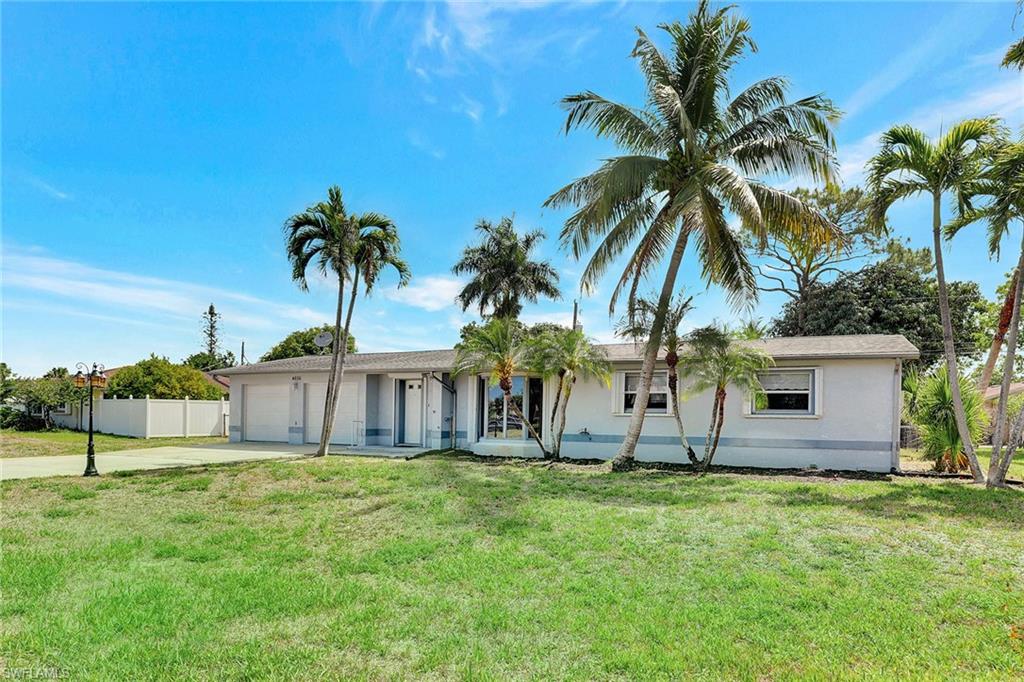 4656 Capri Drive Naples, FL 34103 - Photo 17 of 18 a view of a backyard with a garden
