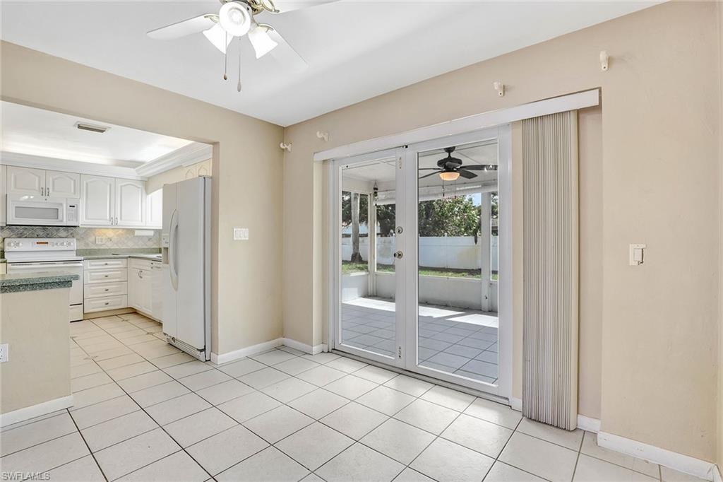 4656 Capri Drive Naples, FL 34103 - Photo 3 of 18 a room with kitchen island and stainless steel appliances