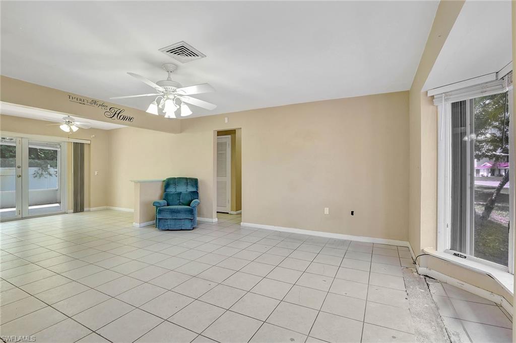 4656 Capri Drive Naples, FL 34103 - Photo 8 of 18 a view of an empty room with a window