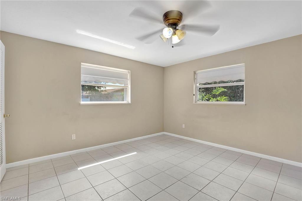 4656 Capri Drive Naples, FL 34103 - Photo 9 of 18 a view of an empty room with a window