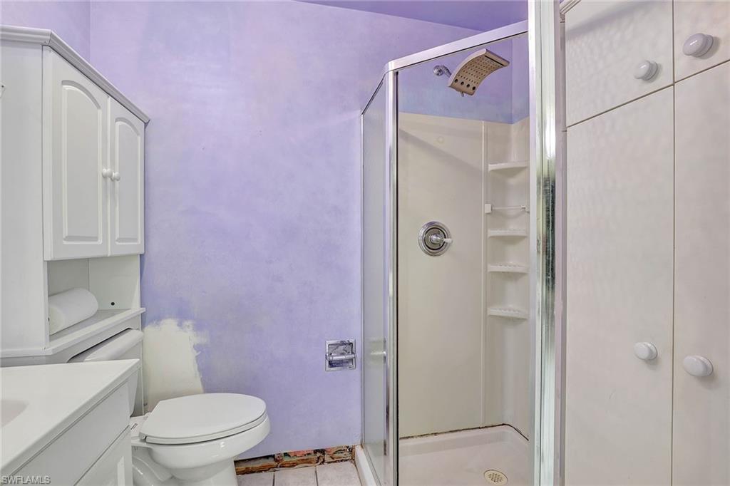 4656 Capri Drive Naples, FL 34103 - Photo 10 of 18 a bathroom with a shower toilet and sink