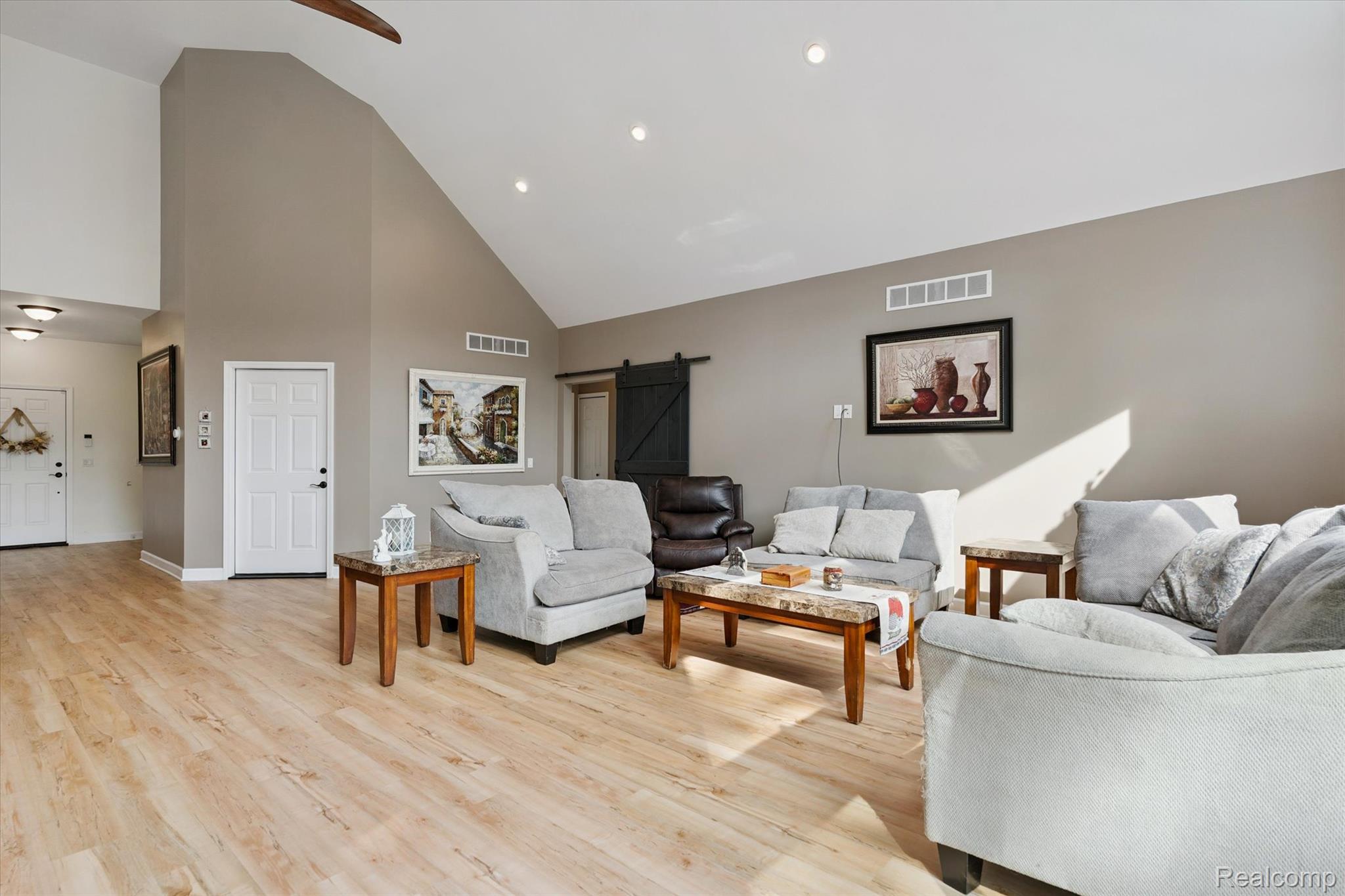441 West Dryden Road Metamora, MI 48455 - Photo 24 of 62 Living area with a barn door, high vaulted ceiling, light wood-type flooring, recessed lighting, and ceiling fan