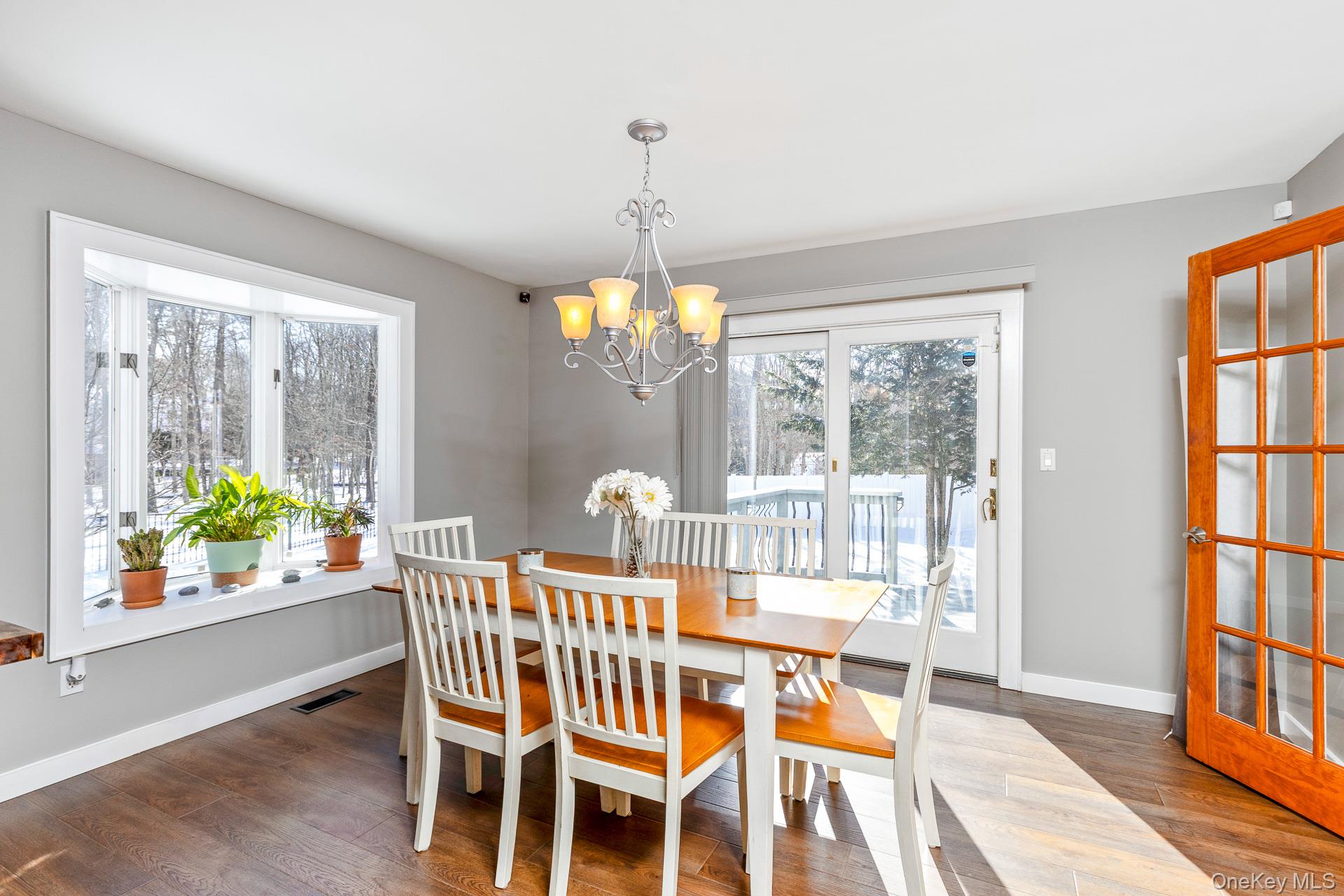 503 Wading River Road Manorville, NY 11949 - Photo 11 of 45 Dining room featuring dark wood finished floors and a chandelier