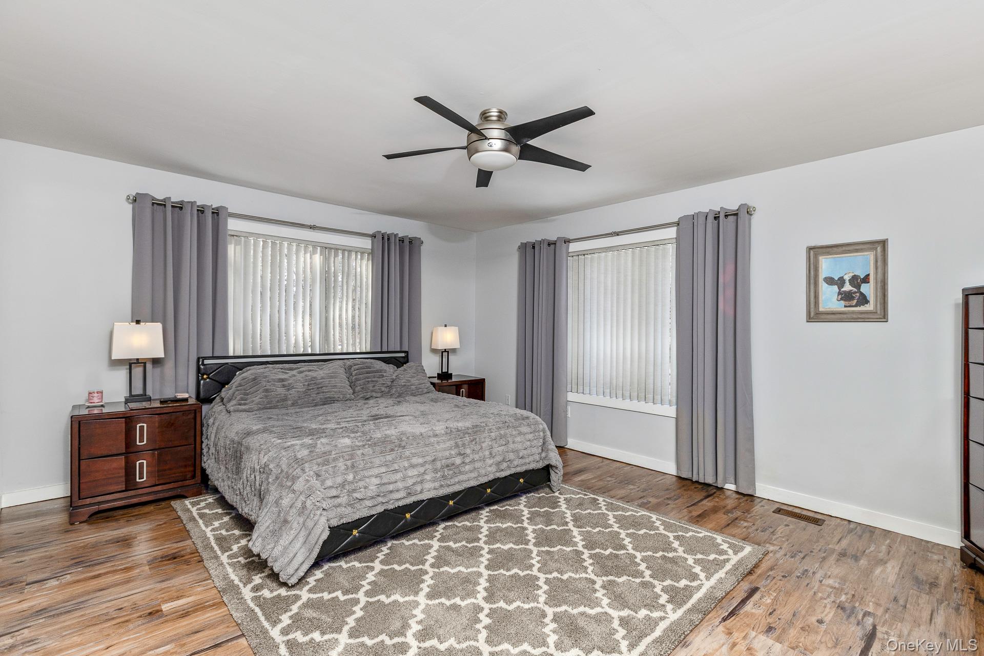 503 Wading River Road Manorville, NY 11949 - Photo 26 of 45 Bedroom featuring a ceiling fan and light wood-type flooring