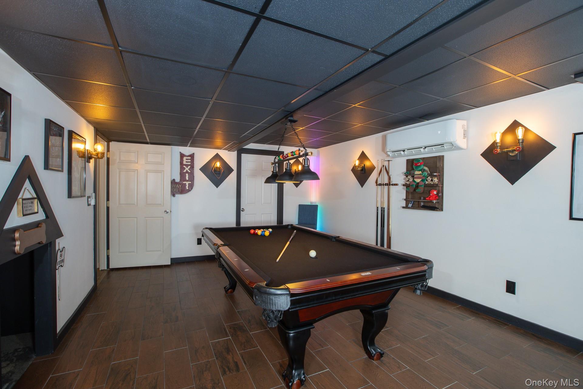 503 Wading River Road Manorville, NY 11949 - Photo 33 of 45 Recreation room featuring billiards, wood tiled floors, a drop ceiling, and a wall mounted air conditioner