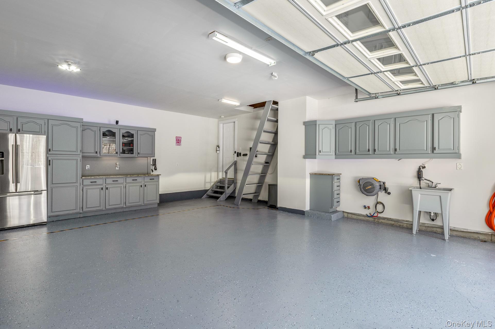 503 Wading River Road Manorville, NY 11949 - Photo 38 of 45 Garage featuring stainless steel fridge and a sink