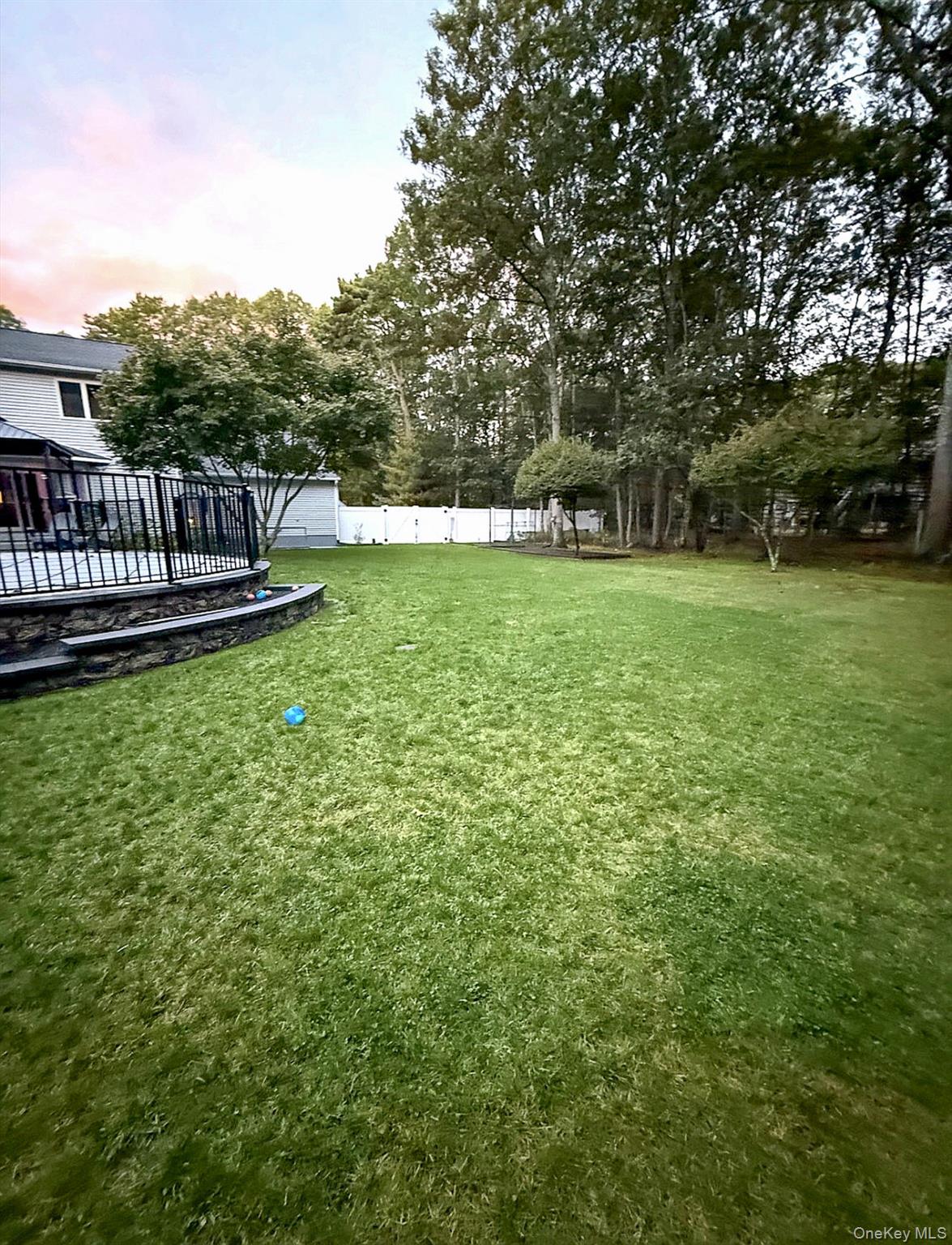 503 Wading River Road Manorville, NY 11949 - Photo 40 of 45 Yard at dusk featuring a fenced backyard and a deck