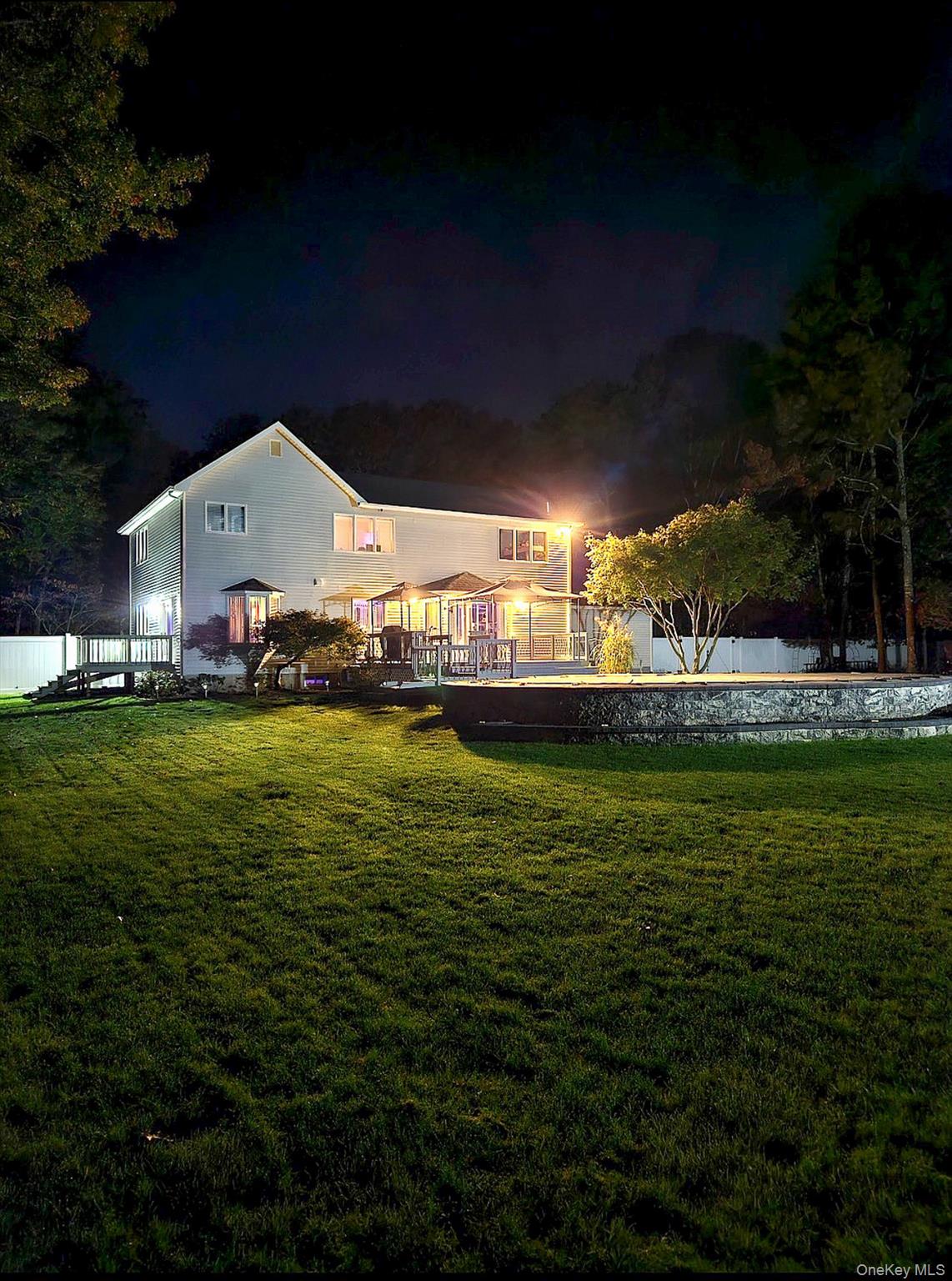 503 Wading River Road Manorville, NY 11949 - Photo 41 of 45 Back of house at twilight with a deck