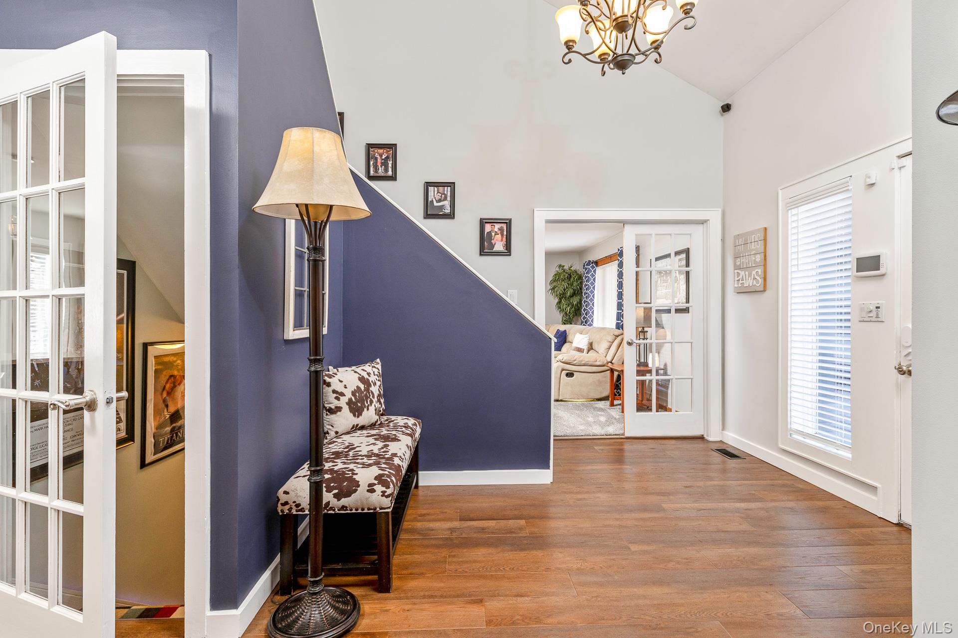 503 Wading River Road Manorville, NY 11949 - Photo 6 of 45 Entrance foyer featuring wood finished floors, a chandelier, high vaulted ceiling, and french doors