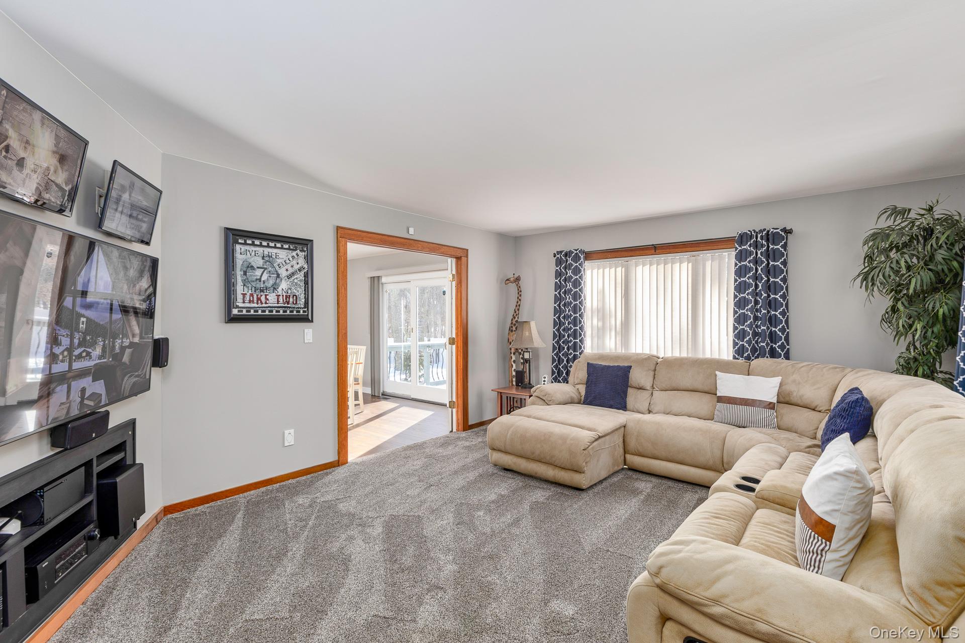 503 Wading River Road Manorville, NY 11949 - Photo 8 of 45 Living area with carpet and baseboards